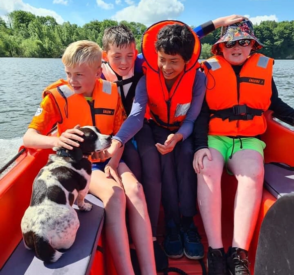 Four young boys have fun on a boat